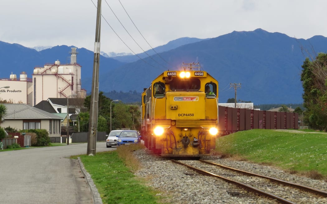 A KiwiRail shunt pulls away from the Westland Milk Products Hokitika site on Gibson Quay. The planned flood protection bank will be to the right of the picture.