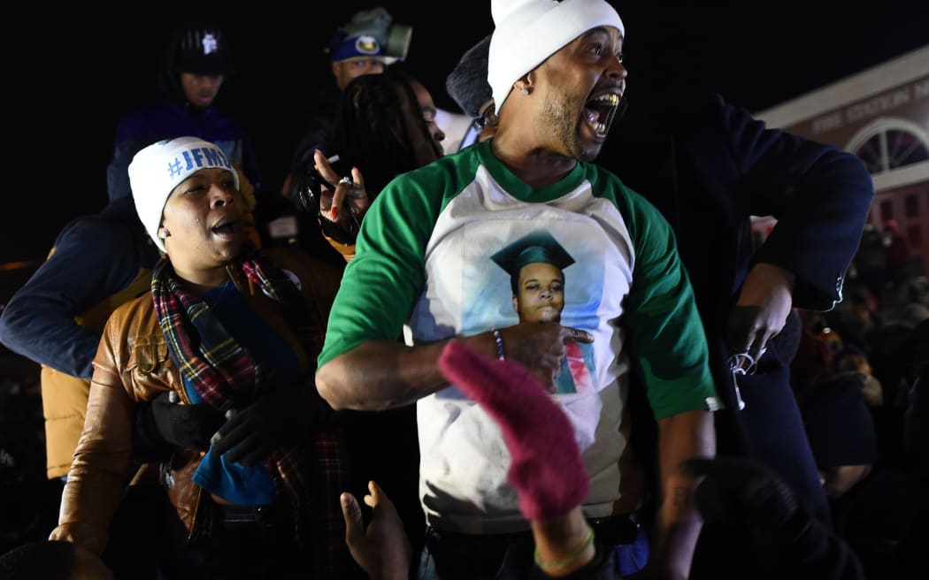 Michael Brown's mother Leslie McSpadden (L) and other protesters react after hearing the grand jury decision.