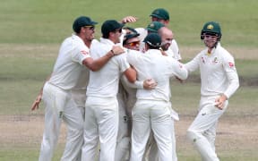 Nathan Michael Lyon of Australia celebrates with teammates after dismissing AB de Villiers of South Africa