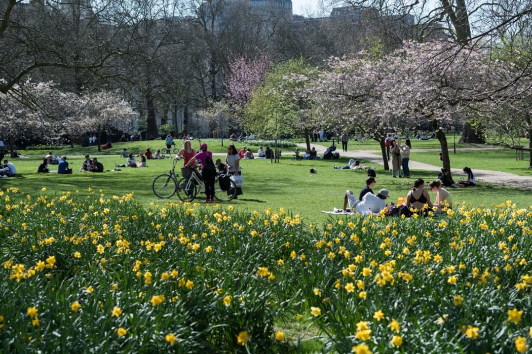 People enjoy exceptionally warm and sunny weather in St James's Park, making the most of eased Coronavirus restrictions, on 30 March, 2021 in London, England.