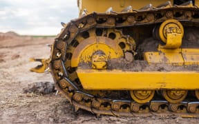 Yellow Tractor on caterpillar tracks, tractor tracks