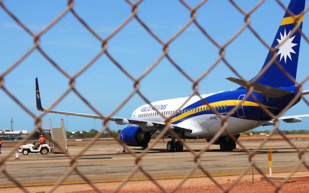 A plane sits on the tarmac at Broome airport before apparently taking a group of foreign nationals who were found in Western Australia's remote Kimberley to Nauru in February 2024. (ABC News: Rosanne Maloney)