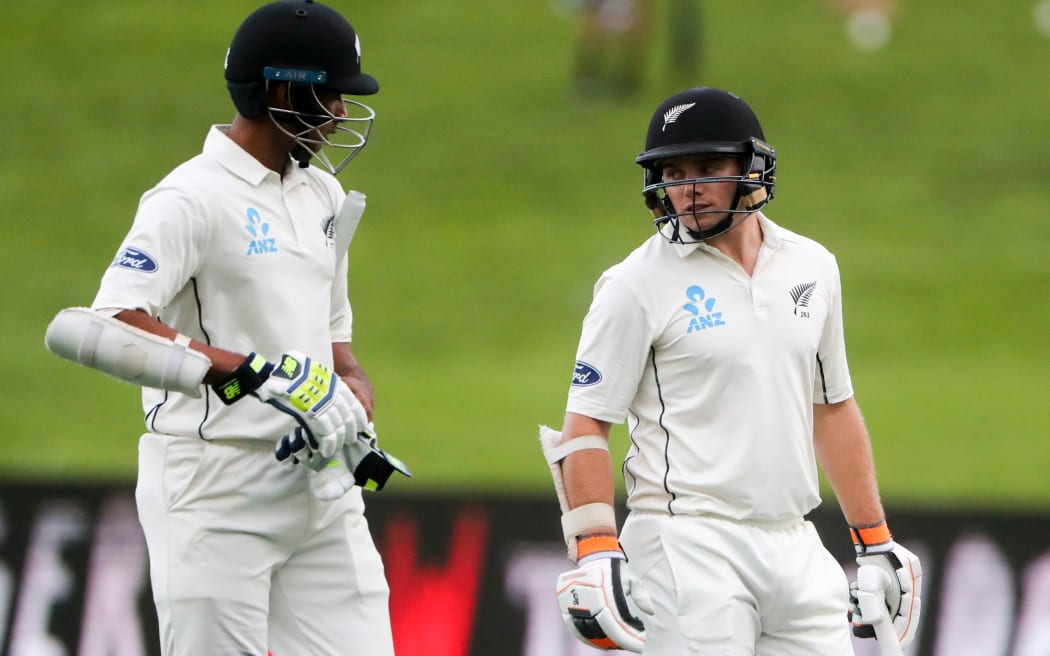 Jeet Raval and Tom Latham leave the field.