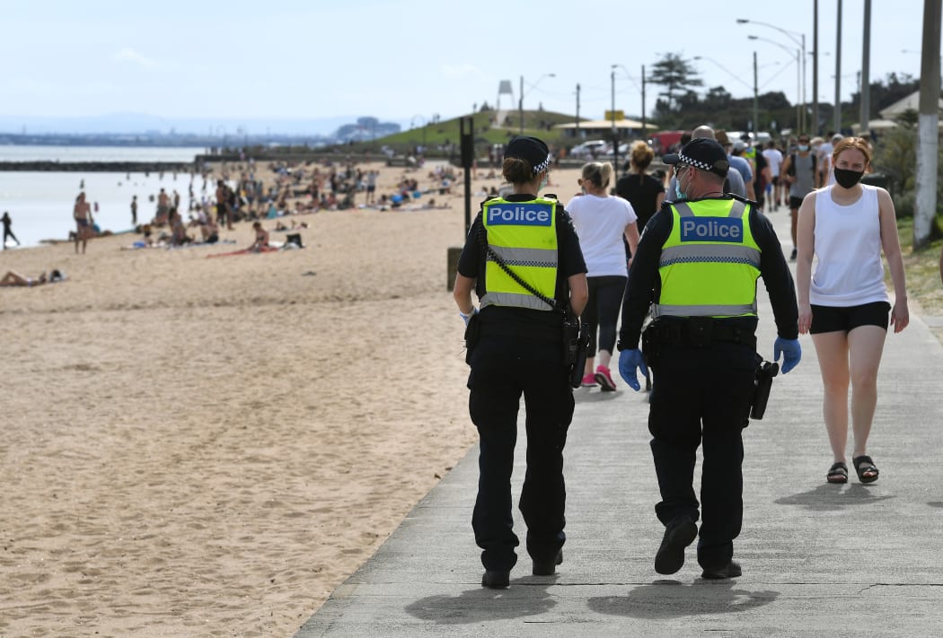 Police enforcing Covid-19 restrictions patrol Elwood Beach in Melbourne in the weekend.