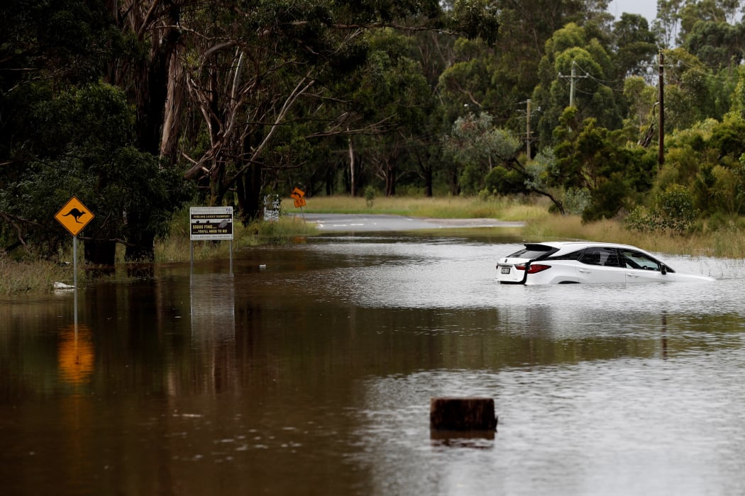 A car floats in floodwaters along the Hawkesbury River in suburban Sydney on March 3, 2022. (