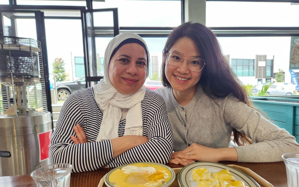 Friends Sheda Madladji and Vivian Doan try durian and mango desserts.