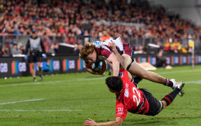 Tim Ryan of the Reds dives over to score a try during the round 11 Super Rugby Pacific match between the Crusaders and Queensland Reds.