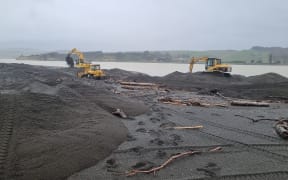 Heavy machinery works to clear the Wairoa river mouth.
