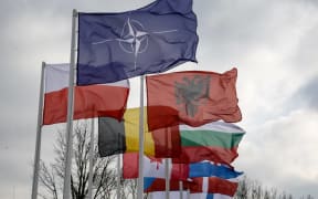 NATO members flags are seen as servicemen exercise ability to cross armored vehicles through Vistula river on ferries during NATO's  Dragon-24 exercise, a part of large scale Steadfast Defender-24 exercise in Korzeniewo, Poland on 4 March 4, 2024.