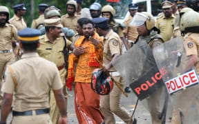 Indian police take a Hindu activist into custody as protesters rallied against a Supreme Court verdict revoking a ban on women's entry to a Hindu temple, in Nilackal in southern Kerala state.