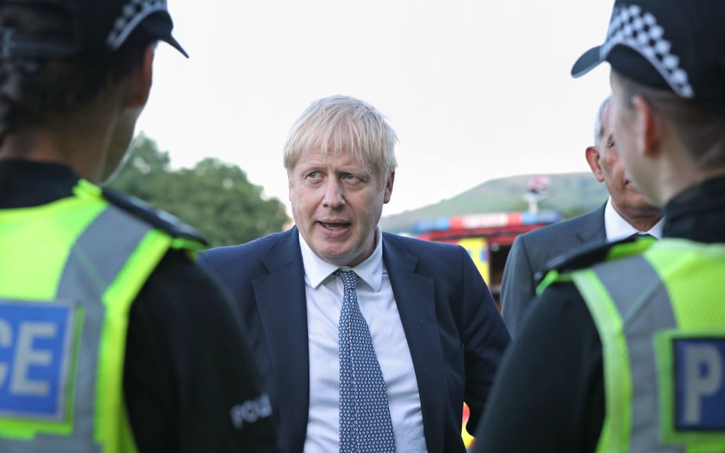 Prime Minister Boris Johnson meets police officers  at Whaley Bridge Football Club in Derbyshire,