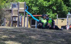 Local police near a playground outside the Hillcrest Primary School the day after five children died and four others were injured.