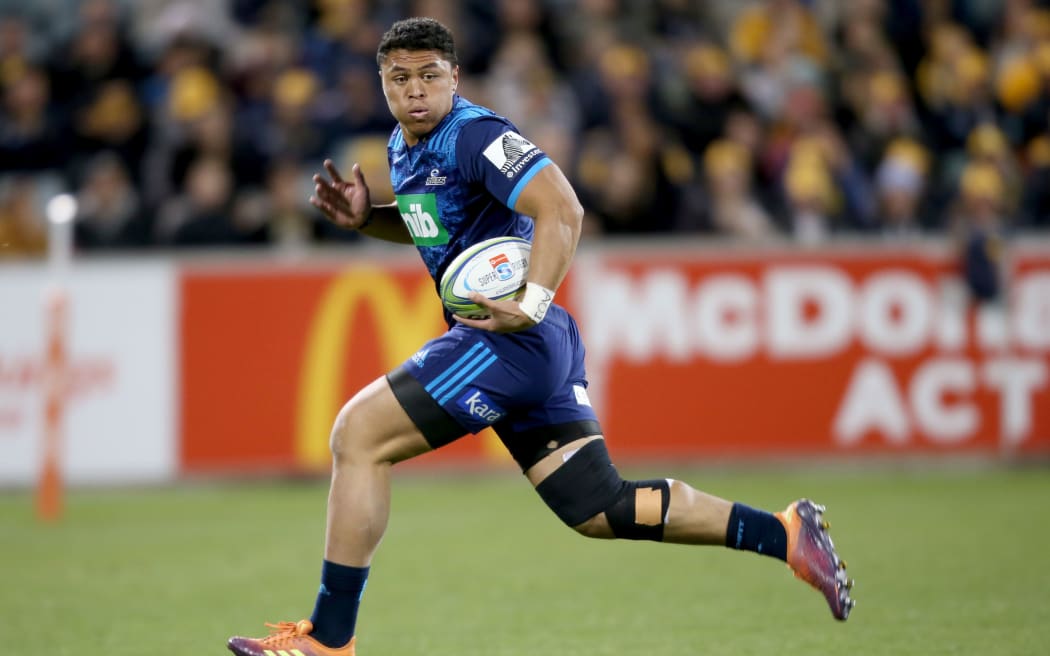 Caleb Clarke makes a break to score a try for the Blues.
