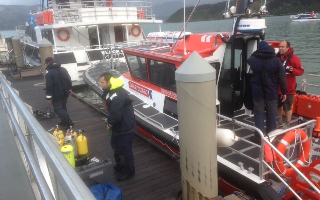A police dive team prepares for a recovery operation.