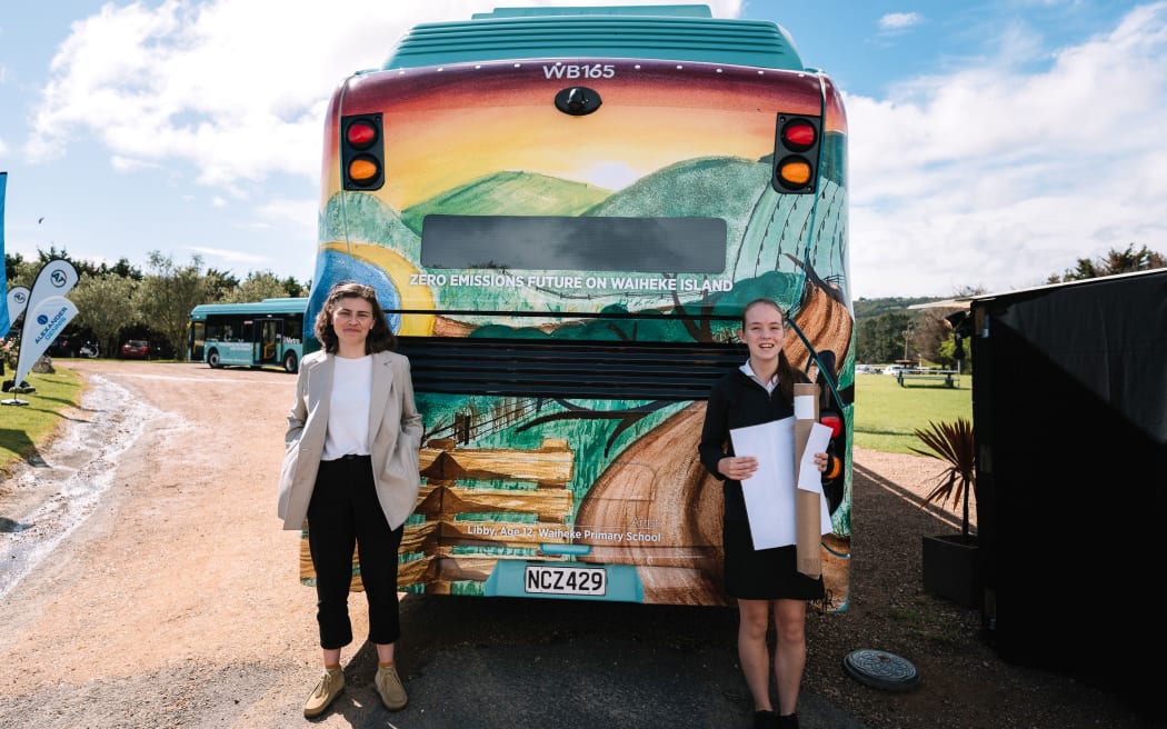 Chloe Swarbrick with youth art competition supreme winner Libby Ramsey- waiheke electric bus fleet