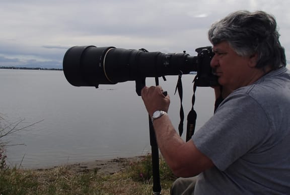 Photographer David Hallett photographing godwits at Christchurch's Heathcote Avon estuary, using his favourite 600 mm zoom lens.