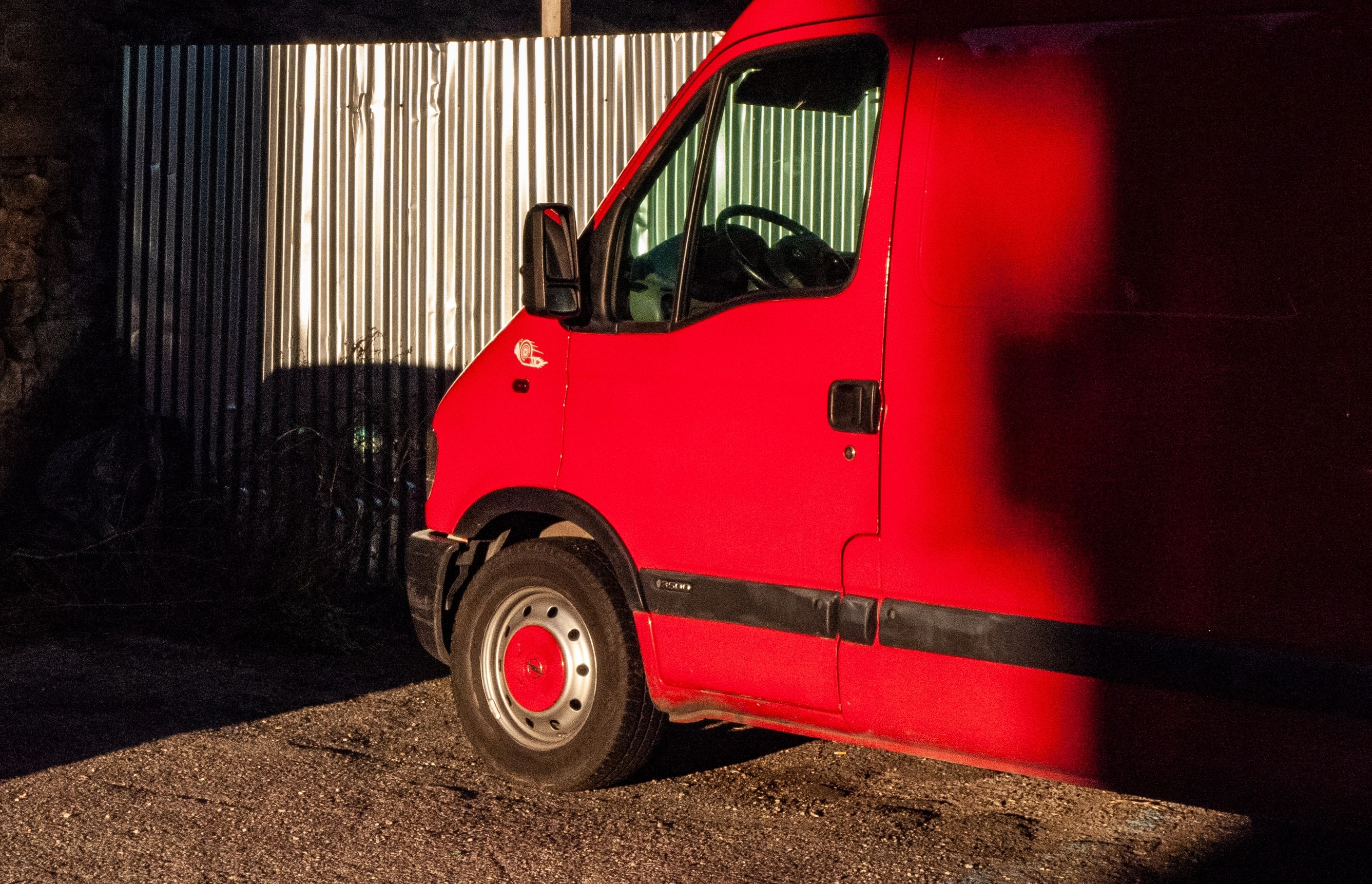 red van and city car parked in the shadows of the buildings. (Photo by: Marco Scataglini/UCG/Universal Images Group via Getty Images)