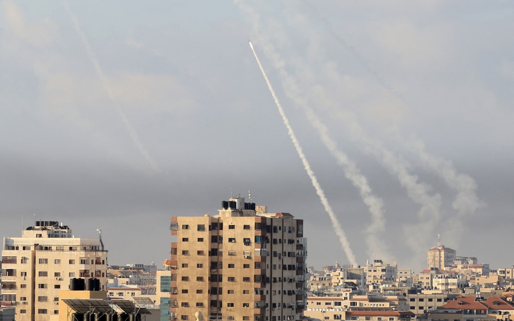 Rockets are fired from Gaza City towards Israel on October 7, 2023. Dozens of rockets were fired from the blockaded Gaza Strip towards Israel on October 7, 2023, an AFP journalist in the Palestinian territory said, as sirens warning of incoming fire blared in Israel. (Photo by MAHMUD HAMS / AFP)