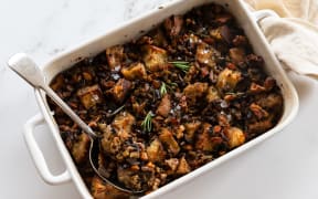 A rectangular baking dish containing Mushroom, rosemary and walnut sourdough stuffing.