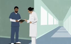 Medical staff conferring in hallway.