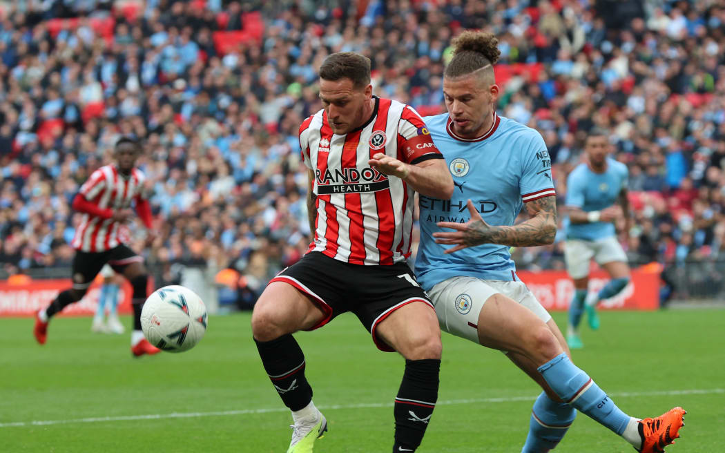 Billy Sharp of Sheffield United tussles with Manchester City's Kalvin Phillips during the FA Cup semi-final match at Wembley on 22nd April