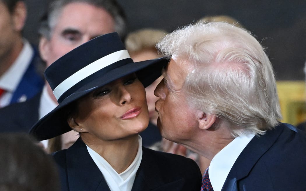 US President-elect Donald Trump kisses Melania Trump as he arrives for the inauguration ceremony before he is sworn in as the 47th US President in the US Capitol Rotunda in Washington, DC, on January 20, 2025.