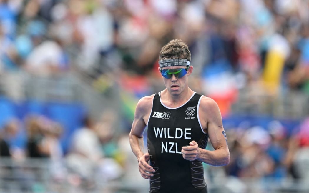New Zealand's Hayden Wilde competes in the running stage during the men's individual triathlon at the Paris 2024 Olympic Games in central Paris on July 31, 2024. (Photo by Andrej ISAKOVIC / AFP)