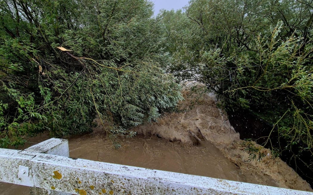 A creek has burst in banks on Lake Ferry Road south of Martinborough, Wairarapa.