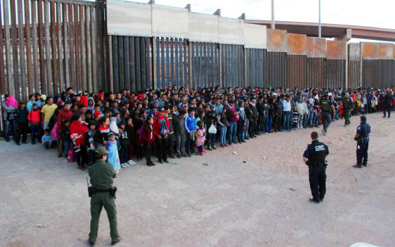 A photo released by US Customs and Border Protection shows migrants who crossed the US-Mexico border in El Paso, Texas