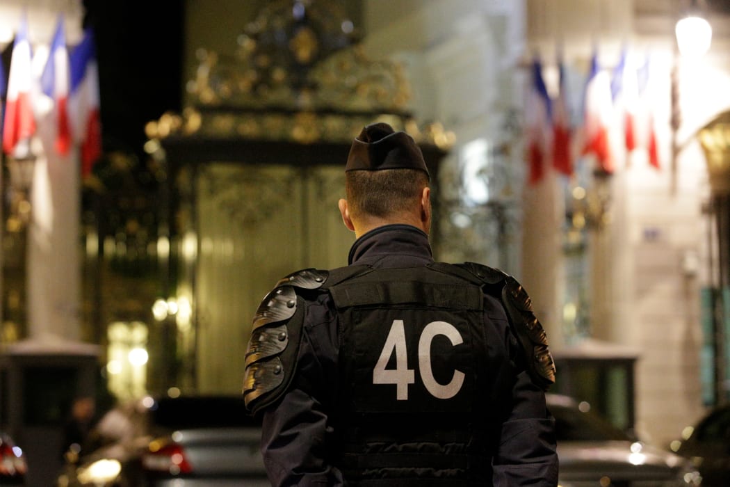 Police officers stand outside the French Interior Ministry in Paris on 15 July 2016.