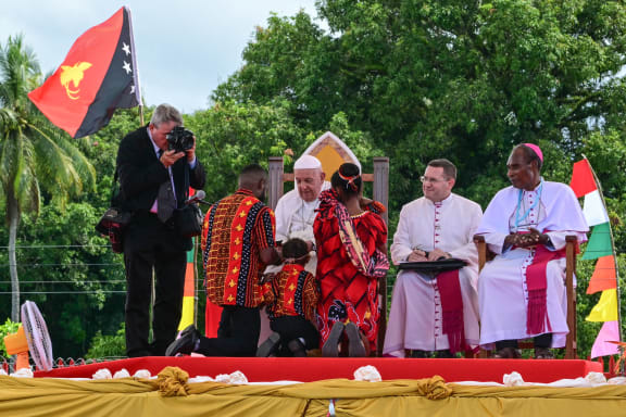 Pope Francis meets people as he takes part in a meeting with Catholic faithful of the diocese of Vanimo in front of Holy Cross Cathedral in Vanimo, Papua New Guinea, on September 8, 2024. (Photo by Tiziana FABI / AFP)