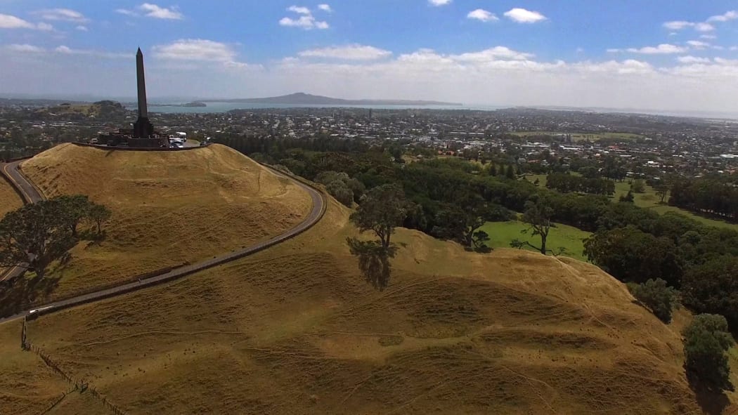 One Tree Hill seen from a drone with Rangitoto and Greenlane suburb in the background.  Auckland, New Zealand