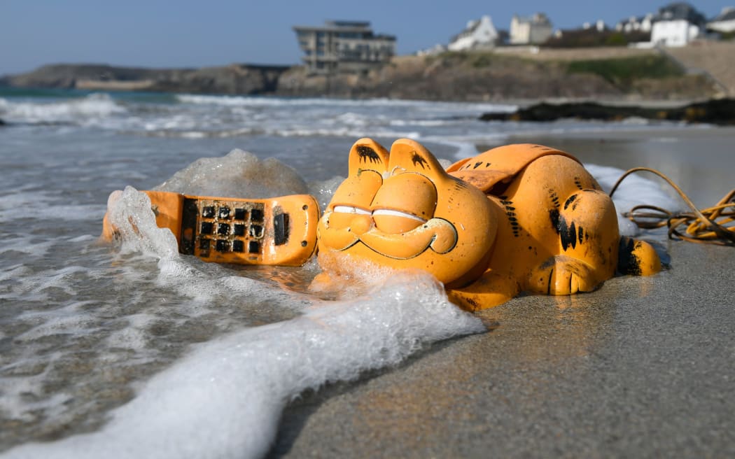A plastic 'Garfield' phone is displayed on the beach in Le Conquet, western France