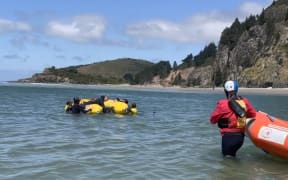 Rescuers help to float a stranded Bottlenose dolphin that was stuck in Blueskin Bay north of Dunedin.