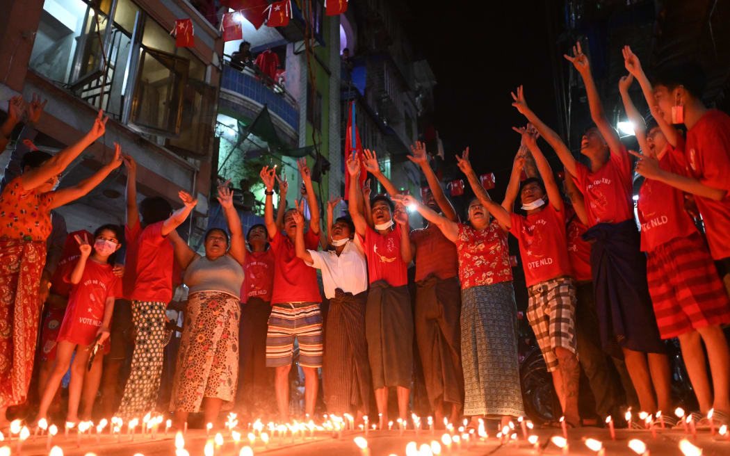 People take part in a noise campaign on the street after calls for protest against the military coup emerged on social media, in Yangon on February 5, 2021.
