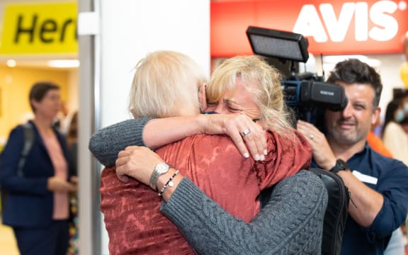 A passenger on the first quarantine-free flight into Auckland embraces with a loved one