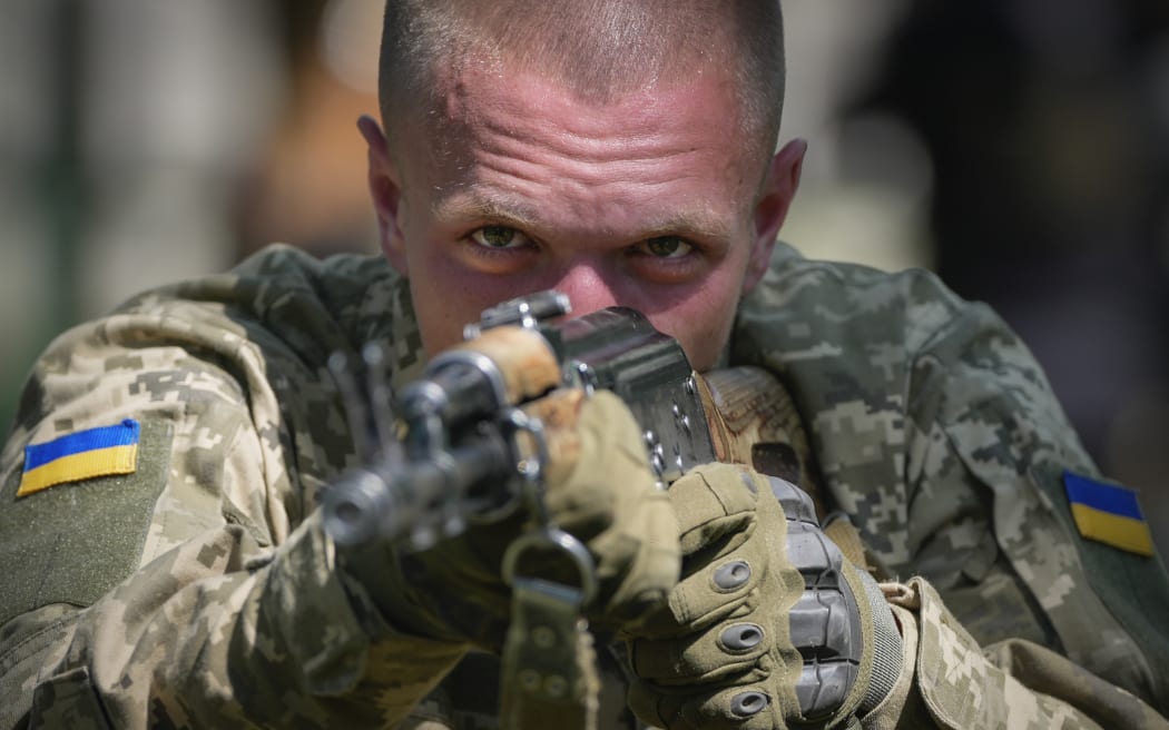 A newly recruited soldier of the 3rd assault brigade trains in Kyiv, Ukraine, Friday, May 17, 2024. A divisive mobilisation law in Ukraine came into force on Saturday, as Kyiv struggles to boost troop numbers after Russia launched a new offensive.