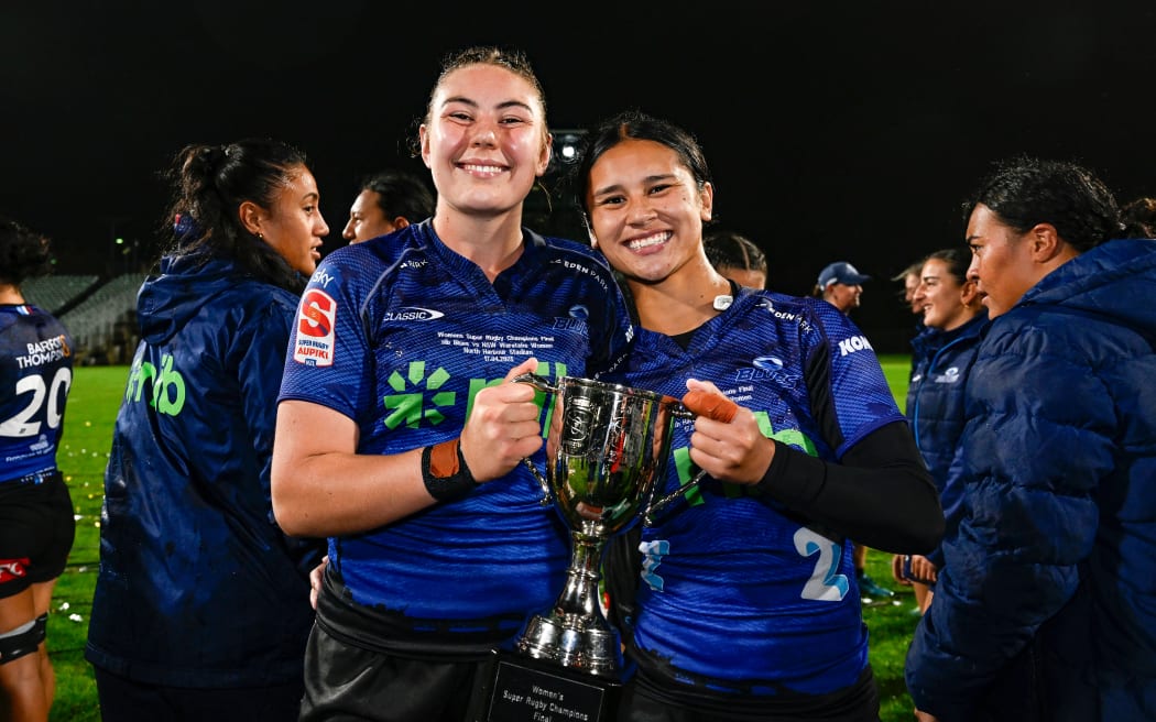 Maiakawanakaulani Roos (captain) of the Blues and Braxton Sorensen-McGee of the Blues pose with the trophy, Blues Women v NSW Waratahs Women, Inaugural Women's Super Rugby Champions Final match at North Harbour Stadium.