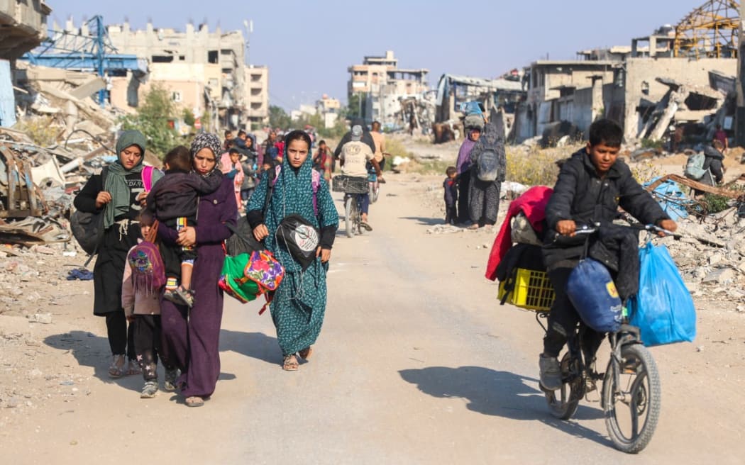 Displaced Palestinians flee Beit Lahia in the northern Gaza Strip, through the main Salah al-Din road on the outskirts of Gaza City, on November 5, 2024, amid the ongoing war between Israel and Hamas.
