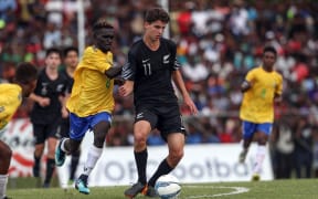 Maxwell Keana closes down New Zealand's Matt Garbett during the OFC Under 16 Championship in 2018.