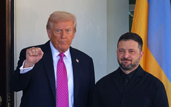 US President Donald Trump gestures as he greets Ukrainian President Volodymyr Zelensky as he arrives for a meeting at the White House in Washington, DC, on October 17, 2025. (Photo by TOM BRENNER / AFP)