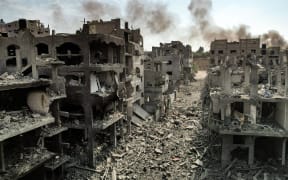 This picture taken on October 11, 2023 shows an aerial view of buildings destroyed by Israeli air strikes in the Jabalia camp for Palestinian refugees in Gaza City. Israel declared war on Hamas on October 8 following a shock land, air and sea assault by the Gaza-based Islamists. The death toll from the shock cross-border assault by Hamas militants rose to 1,200, making it the deadliest attack in the country's 75-year history, while Gaza officials reported more than 900 people killed as Israel pounded the territory with air strikes. (Photo by Yahya HASSOUNA / AFP)