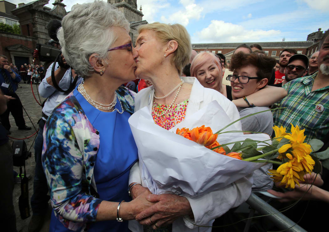 Irish Senator Katherine Zappone (L) kisses her partner Ann Louise Gilligan at Dublin Castle.