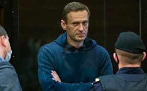 Russian opposition leader Alexei Navalny, charged with violating the terms of a 2014 suspended sentence for embezzlement, stands inside a glass cell during a court hearing in Moscow on February 2, 2021.