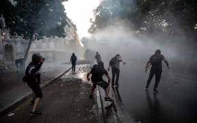 People protest against the economic policies of the government of President Sebastian Pinera and clash with riot polcie in Santiago, Chile.