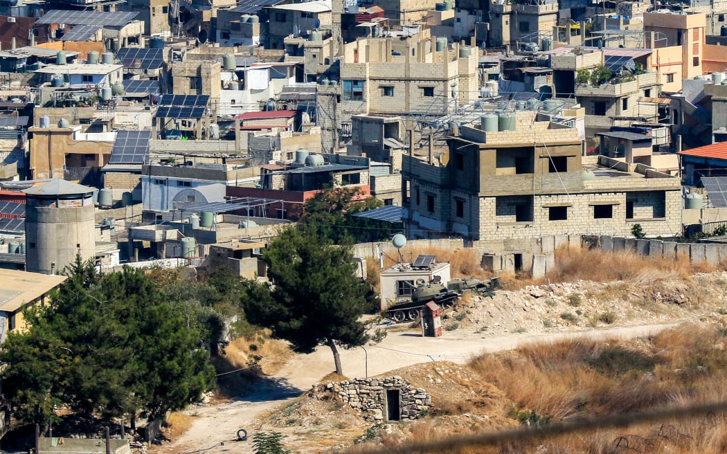 Buildings are pictured in the Ain al-Hilweh camp for Palestinian refugees in Lebanon's southern city of Sidon on September 13, 2025, as armed Palestinian groups in the camp hand over their weapons to Lebanese authorities. Palestinian factions handed over weapons from Lebanon's largest refugee camp on September 13, an official from the Palestine Liberation Organisation (PLO) said, as part of a push by the government to disarm non-state groups. (Photo by MAHMOUD ZAYYAT / AFP)