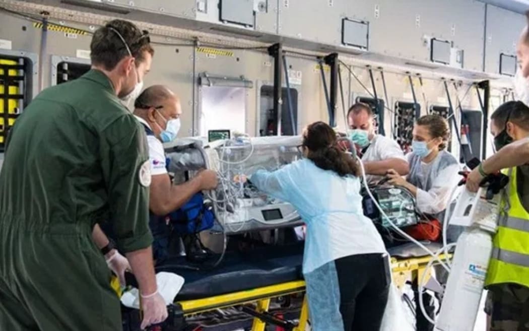 A baby is flown on a special French military flight  from French Polynesia to New Zealand for urgent surgery.