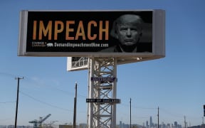 OAKLAND, CA - SEPTEMBER 25: An electronic billboard next to the San Francisco-Oakland Bay Bridge reads "IMPEACH" with an image of U.S. President Donald Trump on September 25, 2017 in Oakland, California.