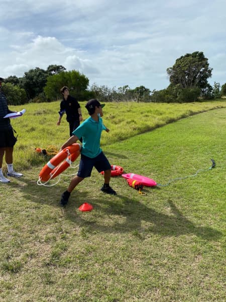 Children practice thrown a rescue ring with Drowning Prevention Auckland.