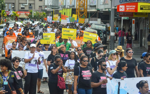 Locals rally against gender-based violence.